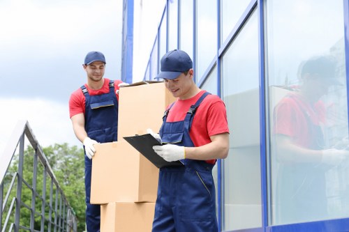 Removal staff handling office equipment during a local Stepney move