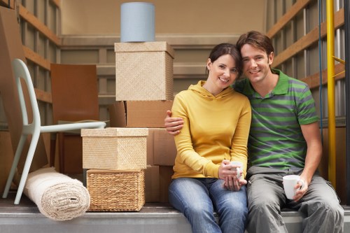 Local moving team organising belongings in a Stepney flat